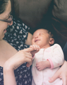 Baby holding mother's finger and laughing  - PhotoDune Item for Sale