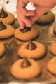 Woman at home making peanut butter blossoms - PhotoDune Item for Sale