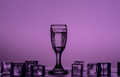 Purple monochrome image of a shot glass and ice cubes on the table  - PhotoDune Item for Sale