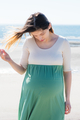 Young millennial pregnant woman on beach  - PhotoDune Item for Sale