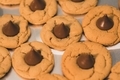 Peanut butter blossoms, cookies with chocolate on wax paper  - PhotoDune Item for Sale