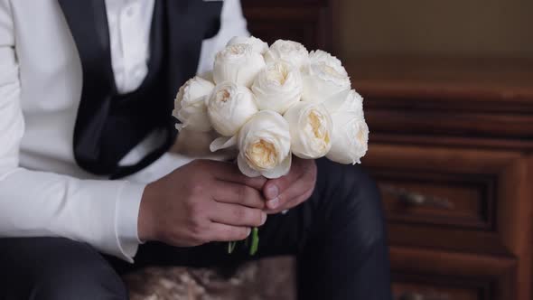 Groom with Wedding Bouquet in His Hands at Home Preparing to Go to Bride Closeup Slow Motion