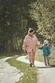 My daughter and mom are walking along the forest path in autumn - PhotoDune Item for Sale