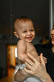 The baby laughs in his mother's arms - PhotoDune Item for Sale