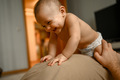 A happy baby is lying on his father's breast - PhotoDune Item for Sale