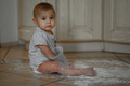The baby at home in the kitchen got dirty in flour - PhotoDune Item for Sale