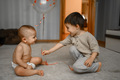 Two brothers are playing, older brother serves the younger one a balloon - PhotoDune Item for Sale