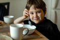 The family is having breakfast. A five-year-old boy eats porridge - PhotoDune Item for Sale