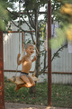 A boy swings on a swing in the summer in the village - PhotoDune Item for Sale