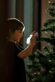 The boy decorates the Christmas tree for the New Year - PhotoDune Item for Sale