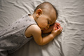 A little boy sleeps sweetly on the bed - PhotoDune Item for Sale