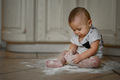 The baby at home in the kitchen got dirty in flour - PhotoDune Item for Sale