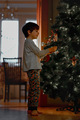The boy decorates the Christmas tree for the New Year - PhotoDune Item for Sale