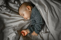 Cute baby sleeps under the blanket at home on the bed - PhotoDune Item for Sale
