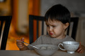 A little boy eats porridge for breakfast - PhotoDune Item for Sale