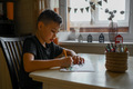 A 10-year-old boy draws a drawing with colored pencils - PhotoDune Item for Sale