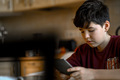 A boy with an e-book is sitting at the table - PhotoDune Item for Sale