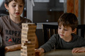 The boys are playing Jeng's game. The brothers are building a tower of wooden sticks - PhotoDune Item for Sale