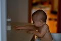 The baby is sitting in a high chair at home in the kitchen - PhotoDune Item for Sale