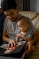 Dad and sons are looking at a family photo album - PhotoDune Item for Sale