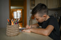 A 10-year-old boy draws a drawing with colored pencils - PhotoDune Item for Sale