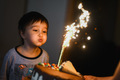 A three-year-old boy blows out candles on a cake in honor of his birthday - PhotoDune Item for Sale