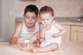 Brothers in the kitchen eating popcorn - PhotoDune Item for Sale