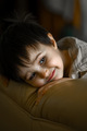 A three-year-old boy is lying at home on the couch. Happy child - PhotoDune Item for Sale
