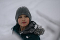 Portrait of a ten-year-old boy in winter in the park against the background of snow - PhotoDune Item for Sale