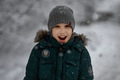 Portrait of a ten-year-old boy in winter in the park against the background of snow - PhotoDune Item for Sale