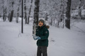 A teenager throws snowballs in the park in winter. Children have fun and play with snow - PhotoDune Item for Sale