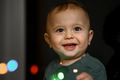 Portrait of a one-year-old baby, the child plays with a glowing garland - PhotoDune Item for Sale