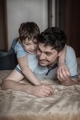 Dad plays with his son. Dad hugs his son - PhotoDune Item for Sale