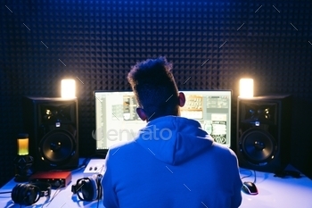 Man working in a modern technological sound and visual studio