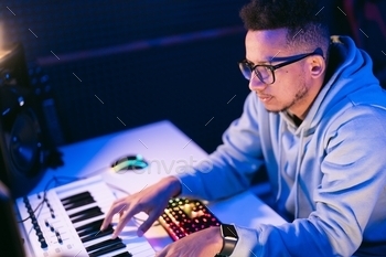 Man working in a modern technological sound and visual studio