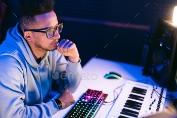 Man working in a modern technological sound and visual studio