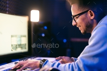 Man working in a modern technological sound and visual studio