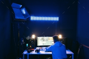 Man working in a modern technological sound and visual studio