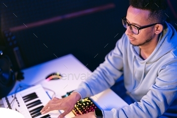 Man working in a modern technological sound and visual studio