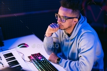 Man working in a modern technological sound and visual studio