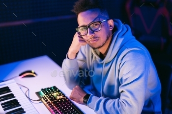 Man working in a modern technological sound and visual studio