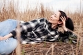 Young woman with closed eyes  in field of dry grass. - PhotoDune Item for Sale