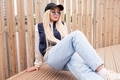 Stylish girl in blue denim pants posing on the city street.  - PhotoDune Item for Sale