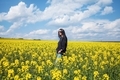 A girl in a field of yellow flowers. - PhotoDune Item for Sale