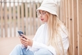 woman looks with happy expression uses mobile phone for chatting online - PhotoDune Item for Sale