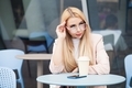 Young beautiful woman drinking coffee cappuccino in a cozy coffee house.  - PhotoDune Item for Sale