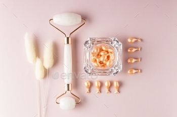 top view of beauty treatment products. Single use capsules with face serum and rose quartz roller