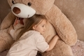 A little girl hugs a big teddy bear. - PhotoDune Item for Sale