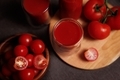 Tomato juice poured into glasses and tomato fruits lying nearby. - PhotoDune Item for Sale