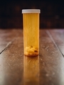 Drugs, pills, medicine in a plastic container on an old wooden table  - PhotoDune Item for Sale